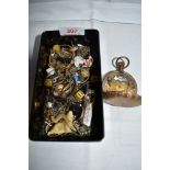 A vintage lidded box containing a small selection of misc including cigar cutter, dice, chains,