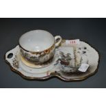 A Chinese eggshell tennis set or tea cup and saucer decorated with stalks and river scene