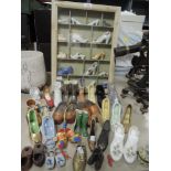 A selection of miniature display shoes and boots in case etc