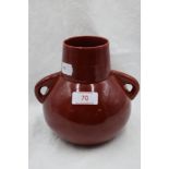 A red Ruskin/Bretby style squat vase having handles to sides.