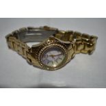 A lady's quartz wrist watch by Guess having baton numeral dial to mother of pearl face with diamante