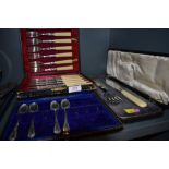 A cased set of fish knives and forks similar cased set of fish servers and a part set of