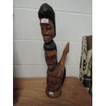 An exotic wood hand carved totem of figure heads