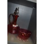 A cranberry glass decanter,beaker and footed bowl.