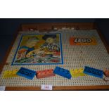 A selection of vintage toy Lego bricks and similar in hand made case