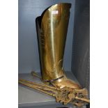 A brass coal bucket in the form of a boot and a fire side set.
