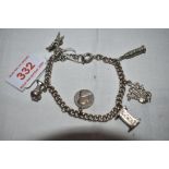 A white metal curb chain bracelet stamped silver having six white metal charms