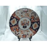 An antique scalloped Imari charger plate with traditional Japanese design