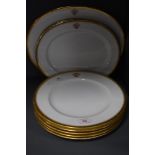 A selection of dinner ware plates and chargers by Copeland having gilt decoration and monogramed