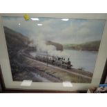 A framed and mounted print depicting steam train on coastal voyage after Dan Breckon.
