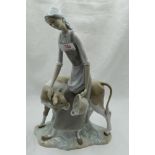 A ceramic figure study by Nao of Girl feeding Calf