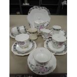 A selection of tea cups and saucers including hand decorated