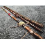A selection of carved and leather work walking or ceremonial sticks