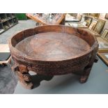 A traditional hand carved and wrought iron Indian Chakki table having good signs of age