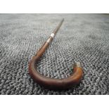 A bent wood bamboo walking cane having HM silver ferrule and tip