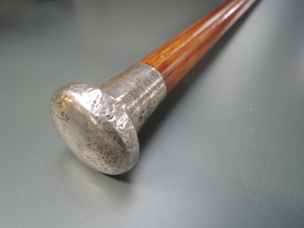 A walking cane having Hm silver handle