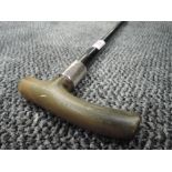 An ebonised walking stick having Hm silver ferrule and bone handle