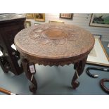 A hand carved Indian table having Elephant head legs and decoration