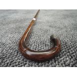 A bent wood walking stick with bamboo style shaft having HM silver tip
