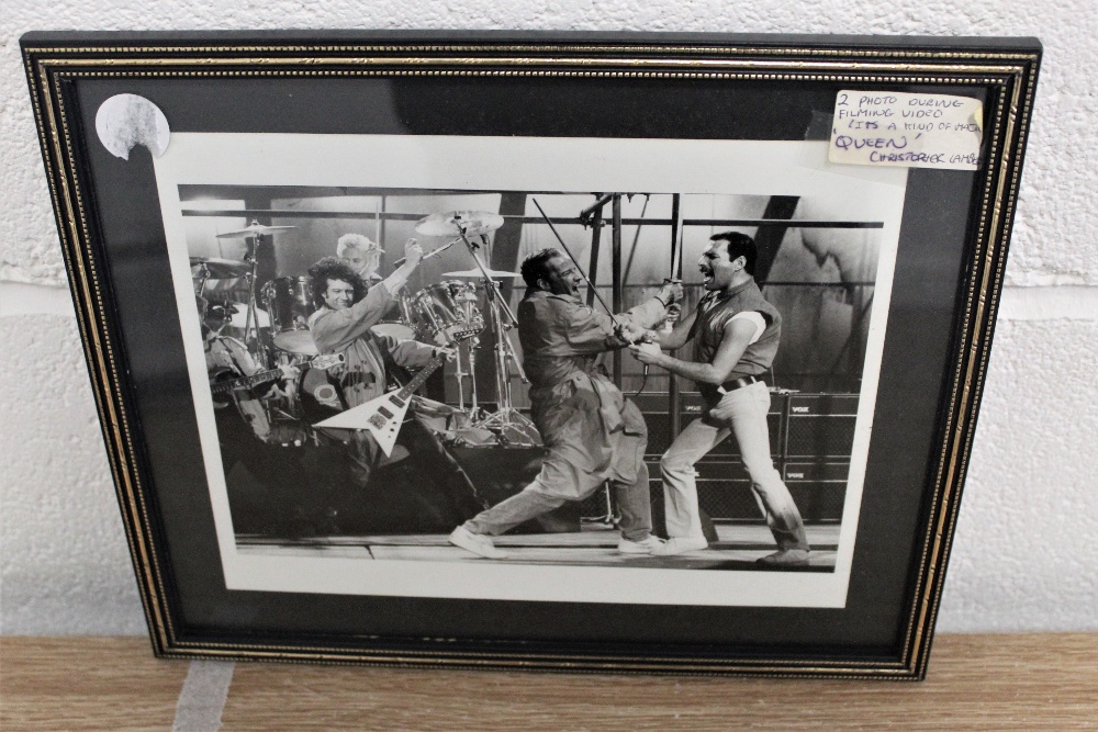 Two framed photos taken during the filming of the' It's a kind of magic' video.