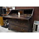 A 19th Century oak bureau, having fitted interior over two over two drawers