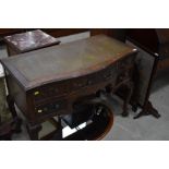 An early 20th Century serpentine front pedestal desk or dressing table, on cabriole legs