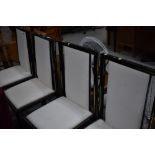 A set of four modern metal (black and gilt) upholstered dining chairs