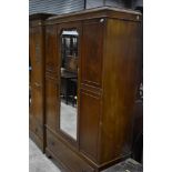 An early 20th Century mahogany mirror door wardrobe having drawer base, width approx. 120cm