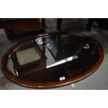 An Edwardian mahogany and inlaid oval wall mirror, approx 87 x 62cm