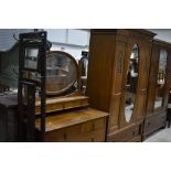 An Art Nouveau period golden oak mirror door wardrobe and dressing table