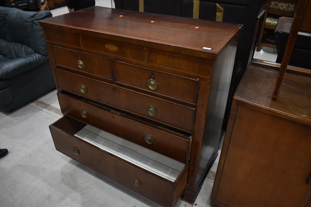 An Edwardian mahogany and inlaid chest of two over three drawers, with additional 'secret' frieze