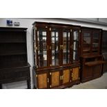 A modern Oriental hardwood bookcase having brass clasps and handles, width approx. 160cm height