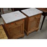 A pair of stripped pine and marble top pot cupboards