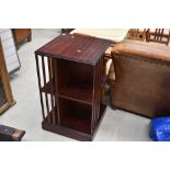 A reproduction mahogany effect revolving bookcase