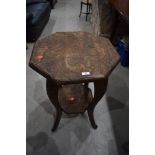 A carved octagonal table, leg broken