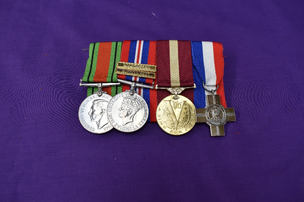 A WW2 group of 4 medals, Defence Medal, War Medal with Gloucestershire Regiment and Suffolk Regiment