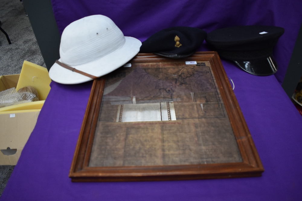 A Military white Pith Helmet, size 7, a black Military Beret and visor cap along with a copy of a