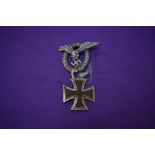 A German WW2 1st Class Iron Cross dated 1939 and a German WW2 Pilot's Badge, makers marks CEJ on