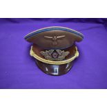 A German WW2 Government Officials Visor Cap ,with eagle and swastika metal badge and swastika and