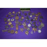 A collection of Military Cap Badges including The Buffs, Devonshire, Middlesex, Suffolk, Borders,