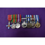 A group of three miniature medals, The Order of the British Empire Medal, Defence Medal and War