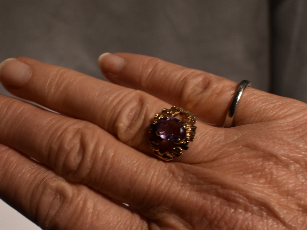 A lady's dress ring having an oval amethyst in a stylised open mount on a 9ct gold loop, size N & - Image 3 of 4