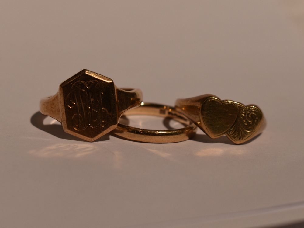 Two 9ct gold signet rings, both size Q and a 9ct gold wedding band, size N, total approx 11.6g