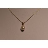 A cultured tear drop pearl and diamond chip pendant on a 9ct gold chain, approx 18' & 1.3g