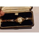 A lady's vintage 9ct gold wrist watch by Leda having a baton and Arabic numeral dial to small face