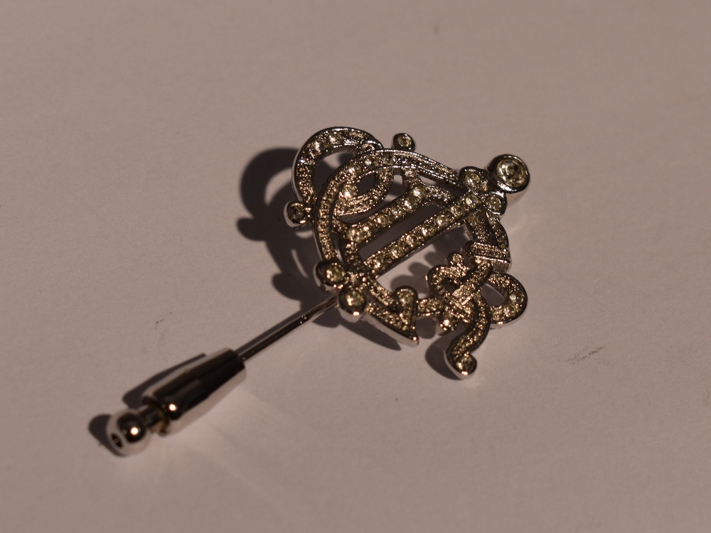 A vintage Christian Dior monogram pin having rhinestone decoration