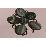 A green stripe agate bracelet having five oval panels in white metal mounts with chain links, no