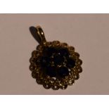 A 9ct gold pendant having a sapphire cluster in an openwork circular mount, no chain, approx 1.6g