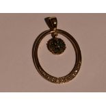 A 9ct gold pendant of loop form having diamond chip decoration and an emerald set cluster drop,