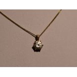 A cubic zirconia solitaire pendant in a claw set 9ct gold mount on a 9ct gold chain, approx 18' with